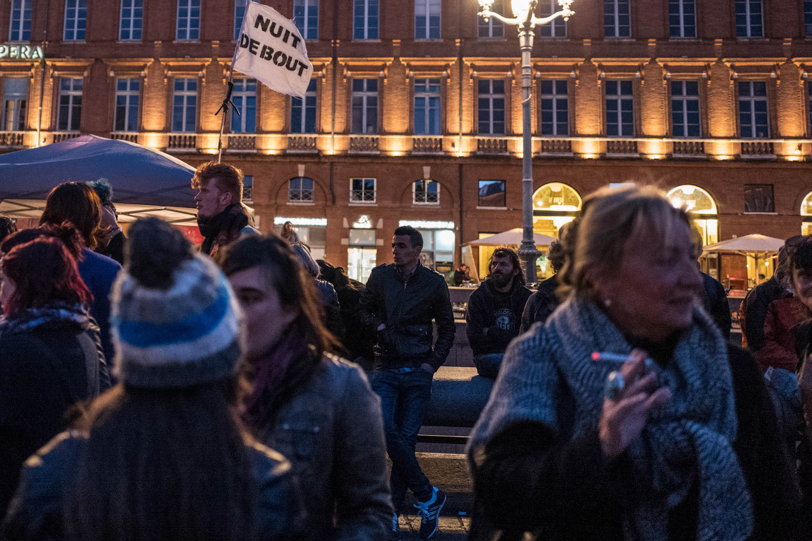 Toulouse, supporters of the 'Nuit Debout' (Up All Night)  at the Capitol sqare in the front of the town hall after the announcement of the use by Socialist Prime Minister Manuel Valls of the article 49.3 of the Constitution to pass the El-Khomri bill on labour reforms with nor vote nor debate in the Parliament. 10 May 2016. Des participants au mouvement  Nuit Debout place du Capitole après l'annonce de l'utilisation par le Premier ministre socialiste Manuel Valls de l'article 49.3 de la Constitution pour passer  le projet de loi sur la réforme du travail. 10 mai 2016, Toulouse-FRANCE.